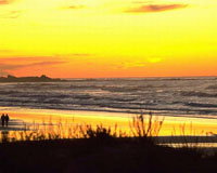 beach orange sunset, tiny couple at left
