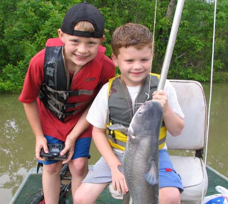 Young brothers Eric & Derek with catfish in boat 