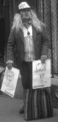 long-haired street man with message hat and caricatures