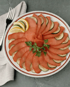 artsy plate of fan-arranged fish with garnish