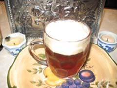 glass of dark beer on flowery plate