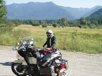 stand beside motorcycle, mountains background