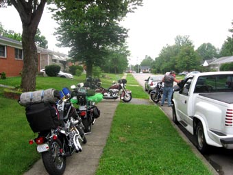 packed motorcycles on subdivision sidewalk